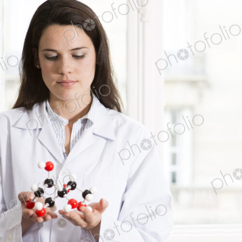 Caucasian scientist examining molecular model