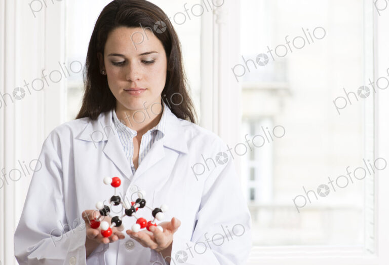 Caucasian scientist examining molecular model