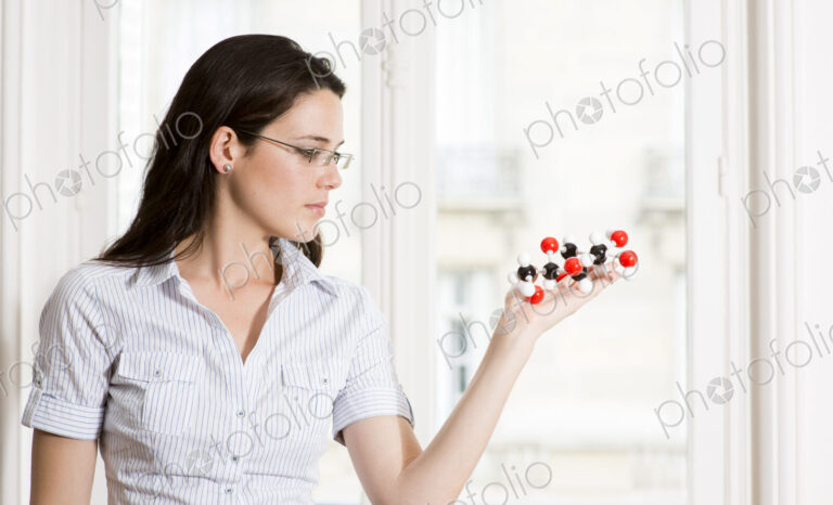 Caucasian scientist examining molecular model