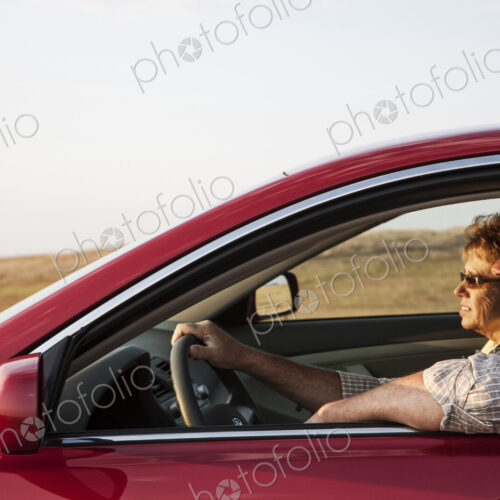 Caucasian senior couple in a car on a road trip.