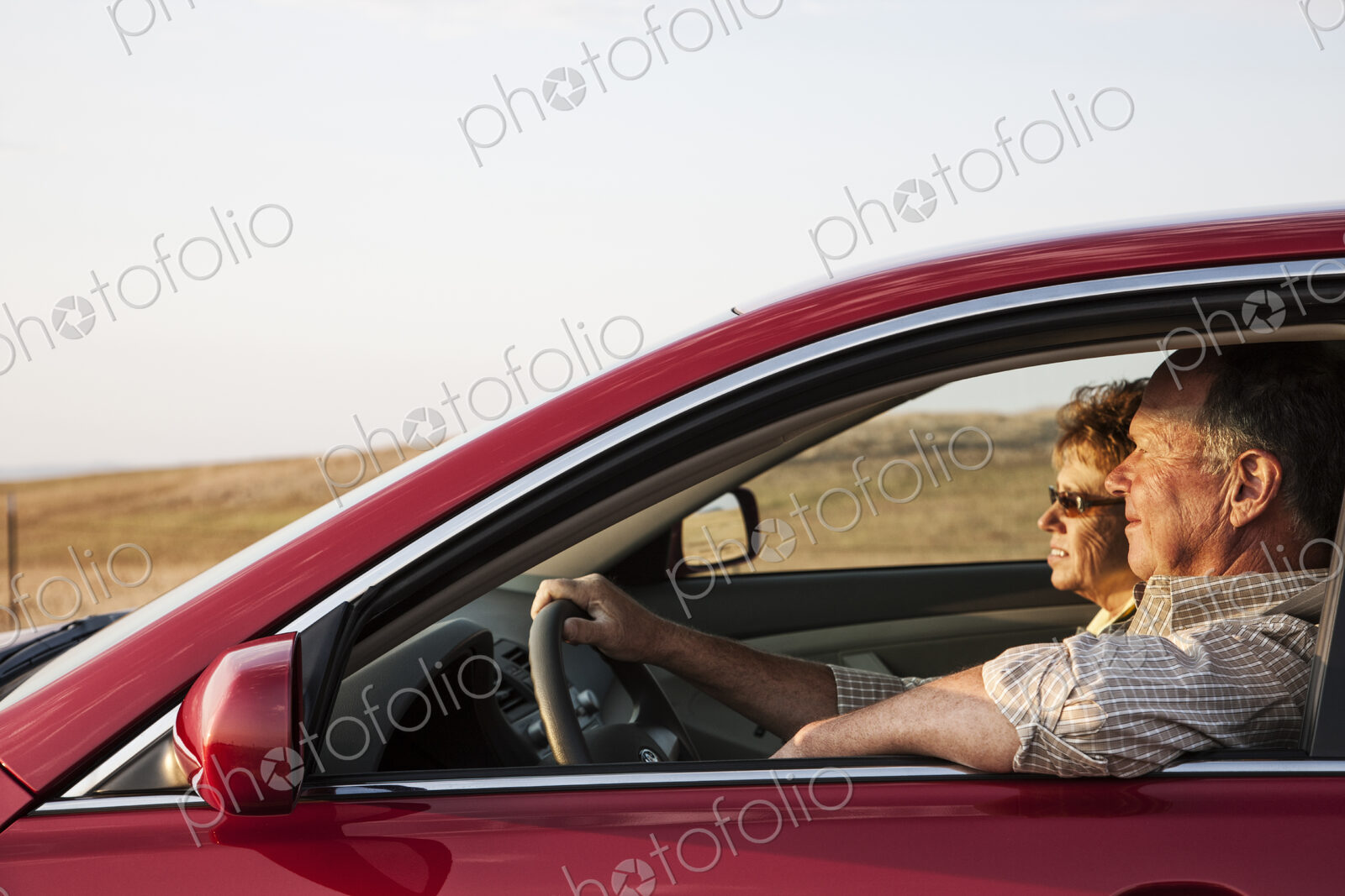 Caucasian senior couple in a car on a road trip.