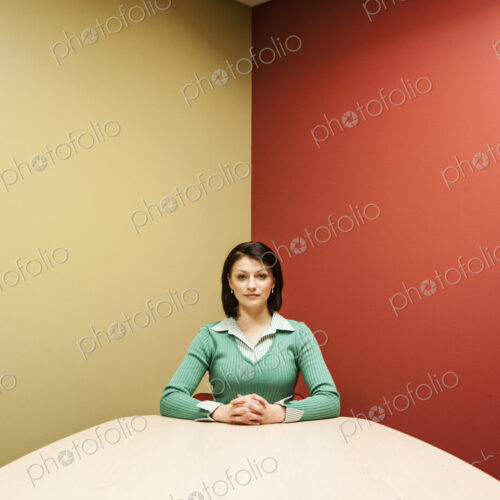 Caucasian woman at a colorful conference room table