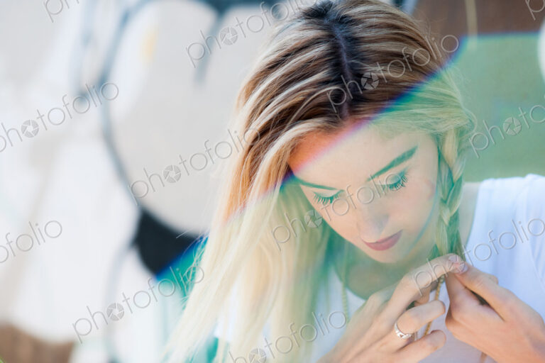 Caucasian woman braiding her hair