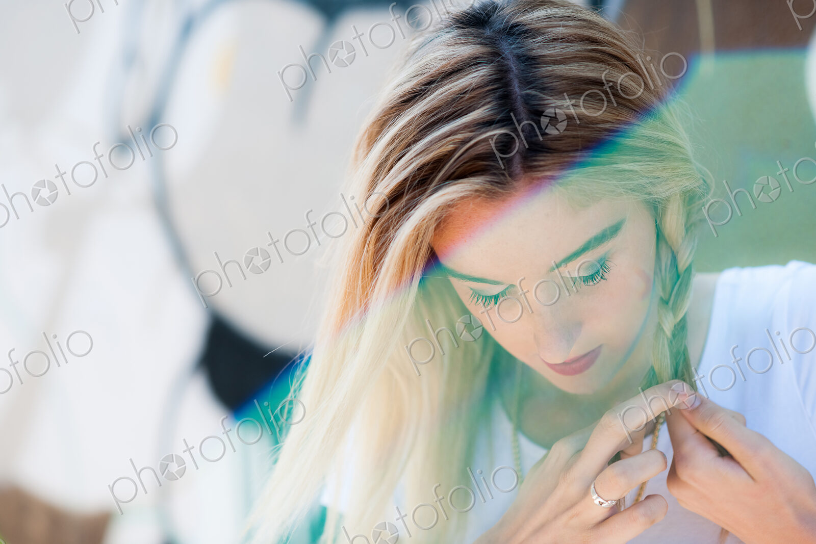 Caucasian woman braiding her hair