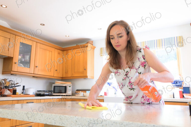 Caucasian woman cleaning kitchen counter