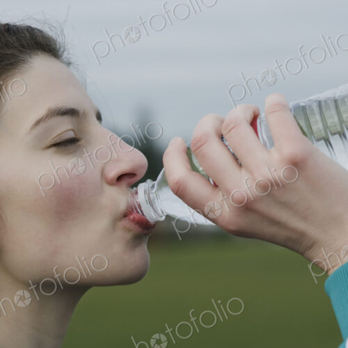 Caucasian woman drinking water from a bottle. Caucasian woman drinking water from a bottle.