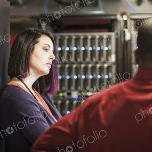 Caucasian woman in a large computer server farm.