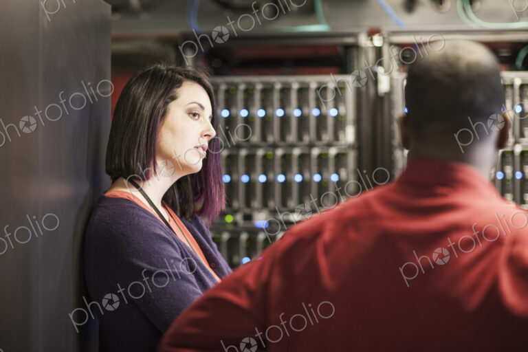 Caucasian woman in a large computer server farm.