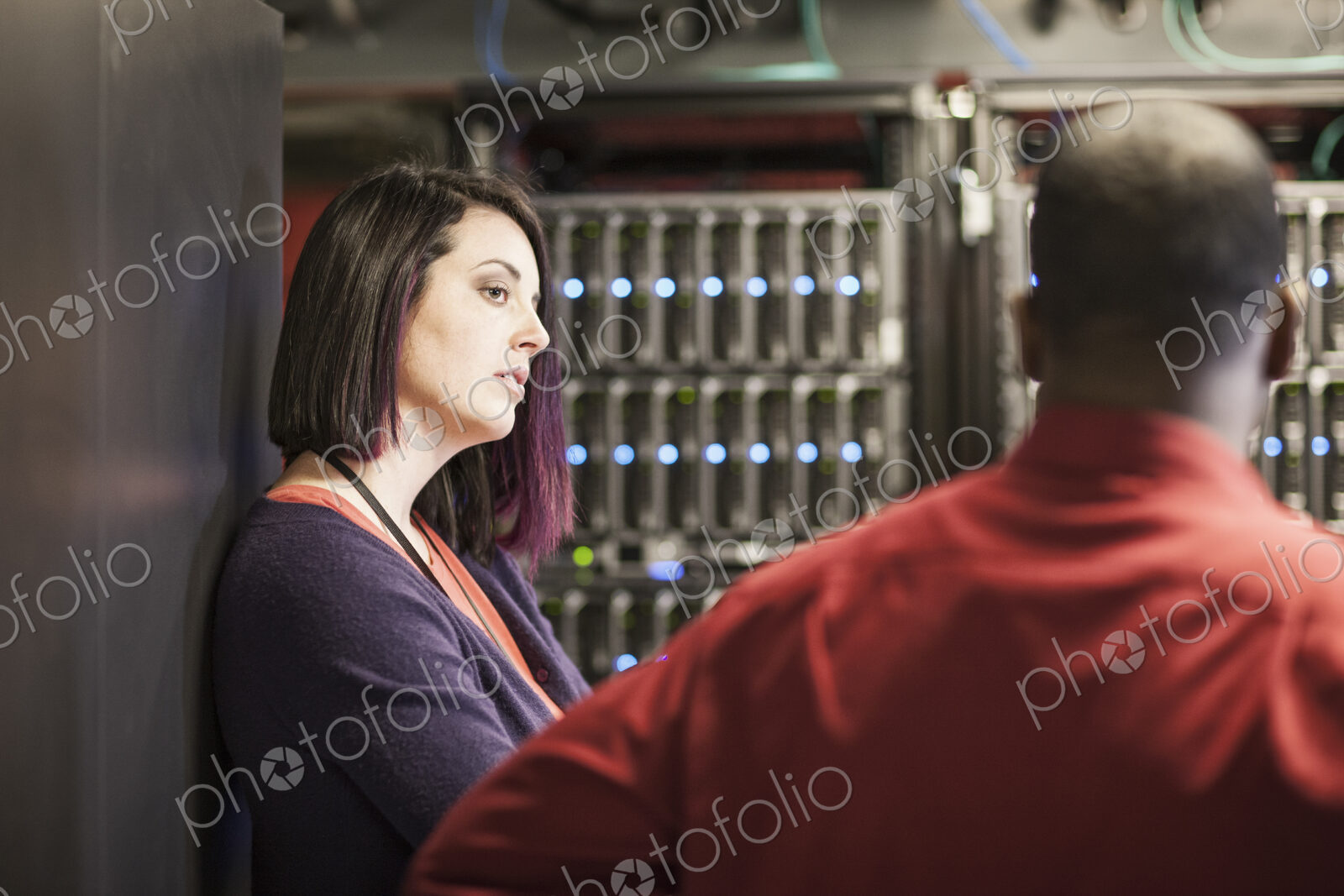 Caucasian woman in a large computer server farm.