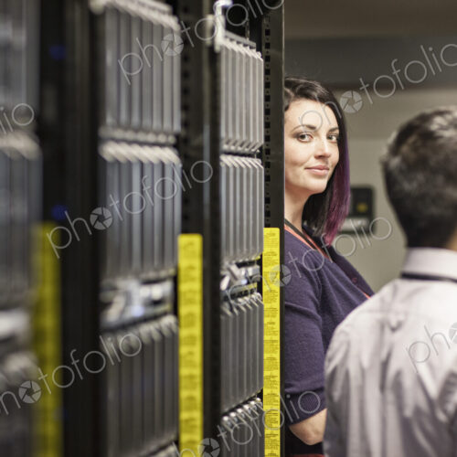 Caucasian woman in a large computer server farm. Caucasian woman in a large computer server farm.