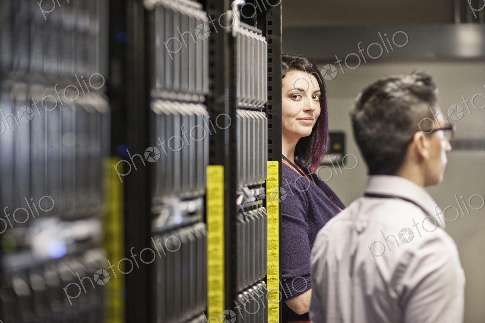 Caucasian woman in a large computer server farm.