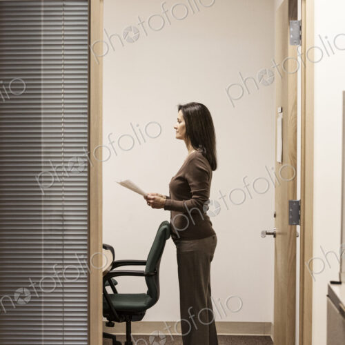 Caucasian woman in a meeting in an exectuive office.