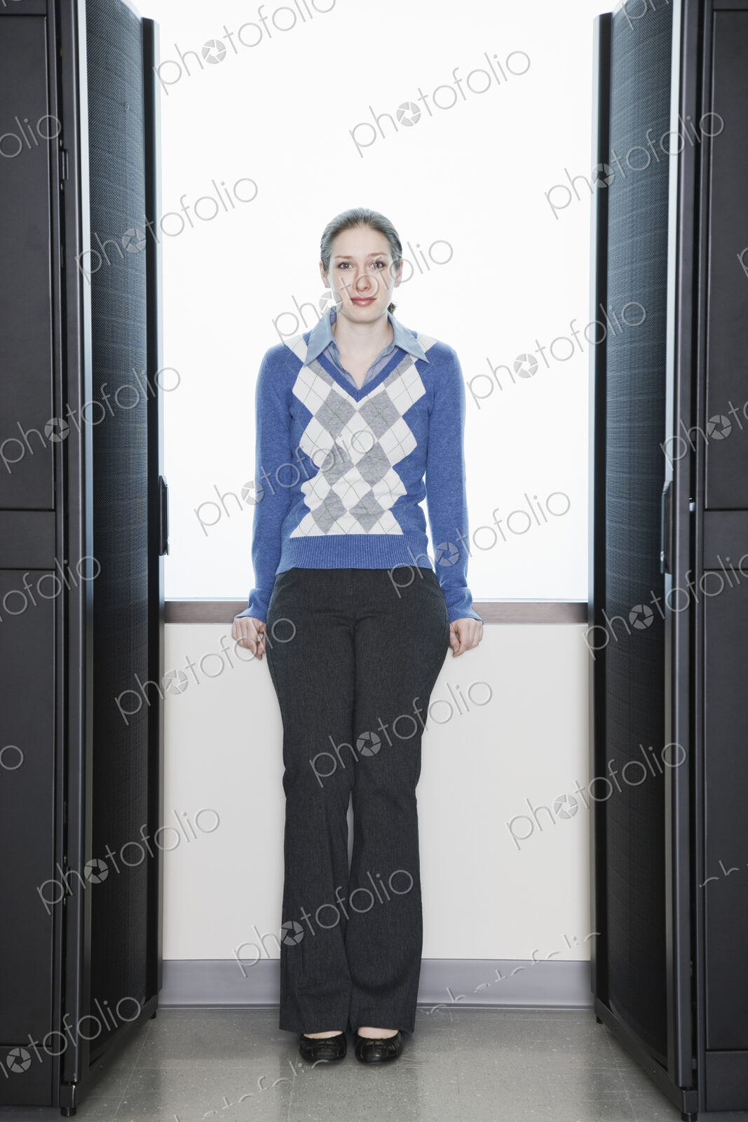 Caucasian woman lab technician next to racks in a computer server farm