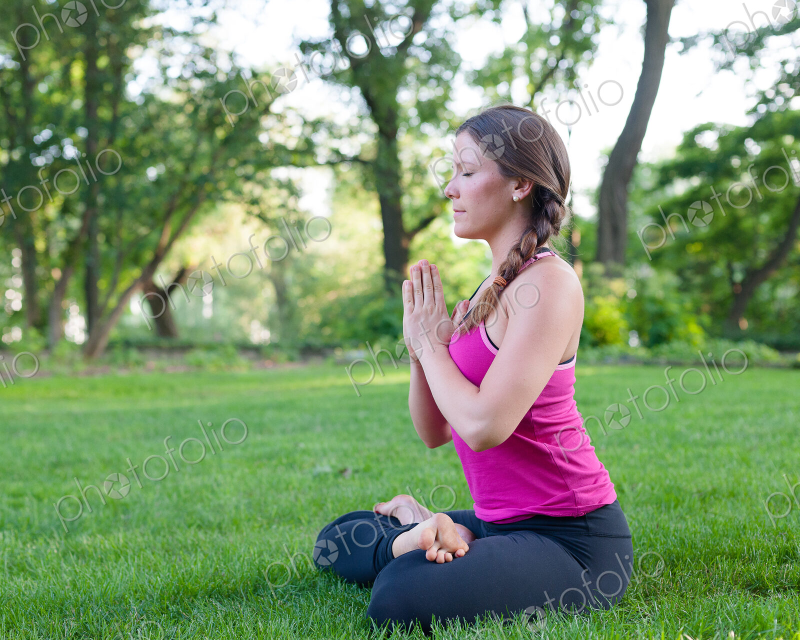 Caucasian woman meditating in park