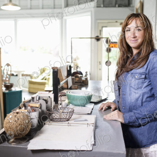 Caucasian woman owner of a small antique store. Caucasian woman owner of a small antique store.
