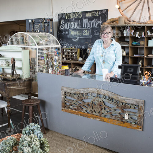 Caucasian woman owner of an antique store standing near the cash register Caucasian woman owner of an antique store standing near the cash register