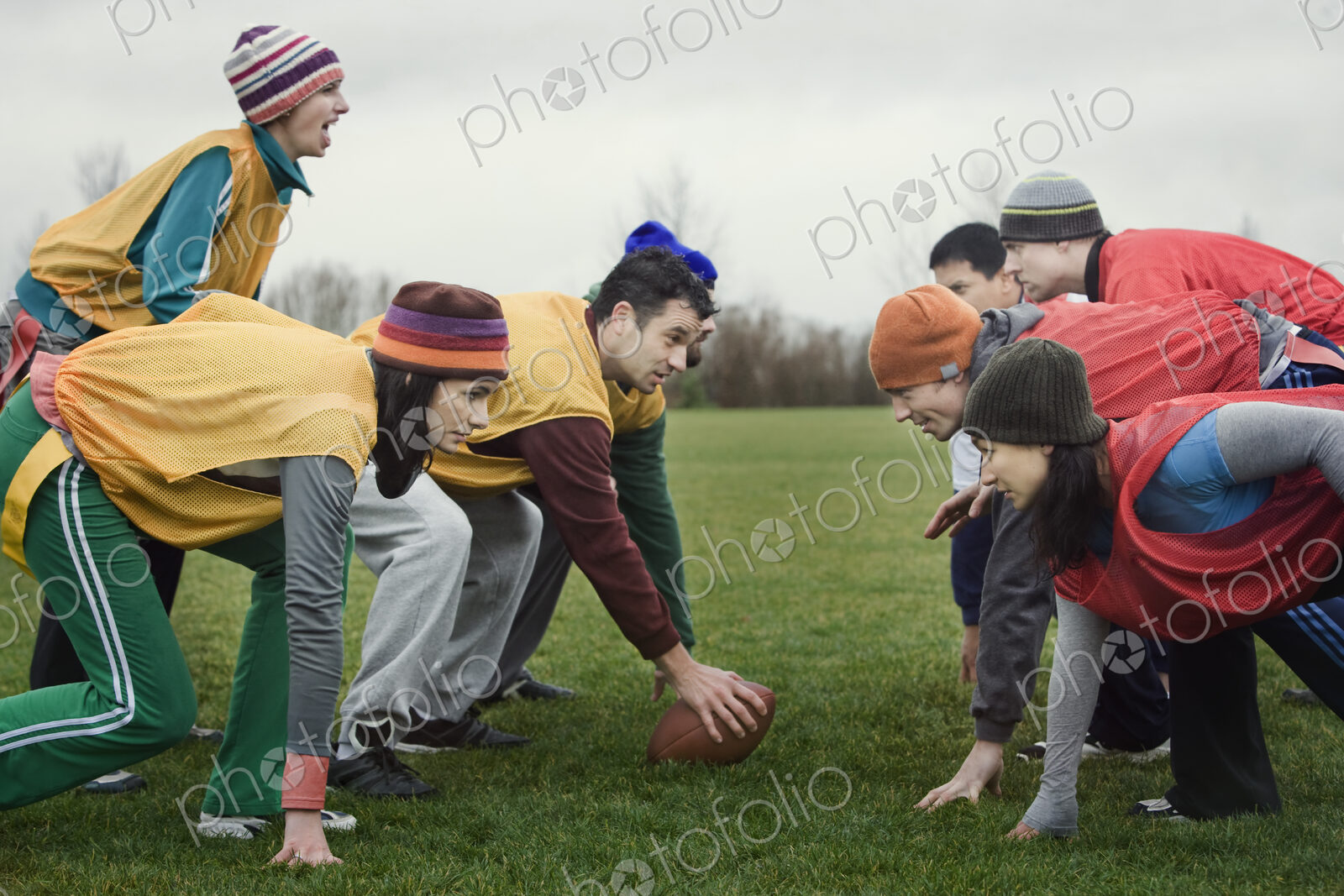 Caucasian woman playing quarterback for a team of friends playing non-contact flag…