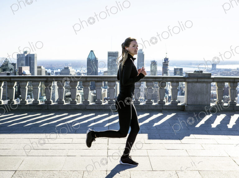 Caucasian woman running in city