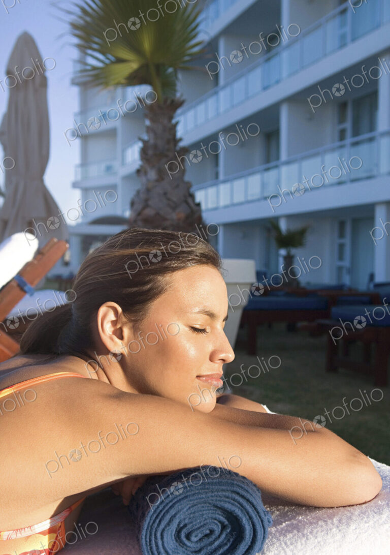 Caucasian woman sunbathing in lawn chair