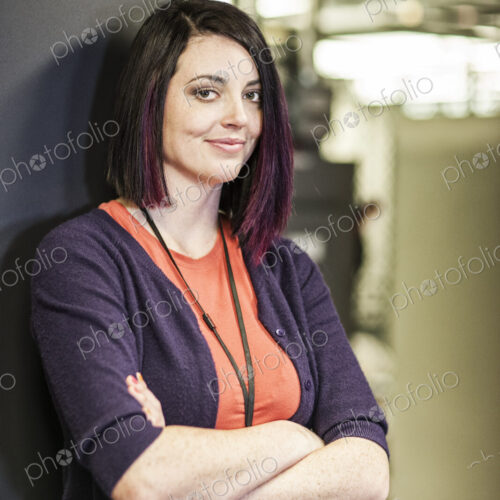 Caucasian woman technician in a large computer server farm.
