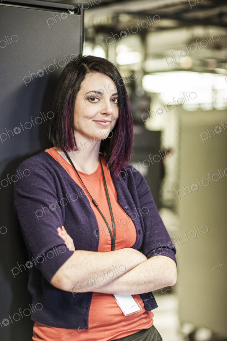 Caucasian woman technician in a large computer server farm.