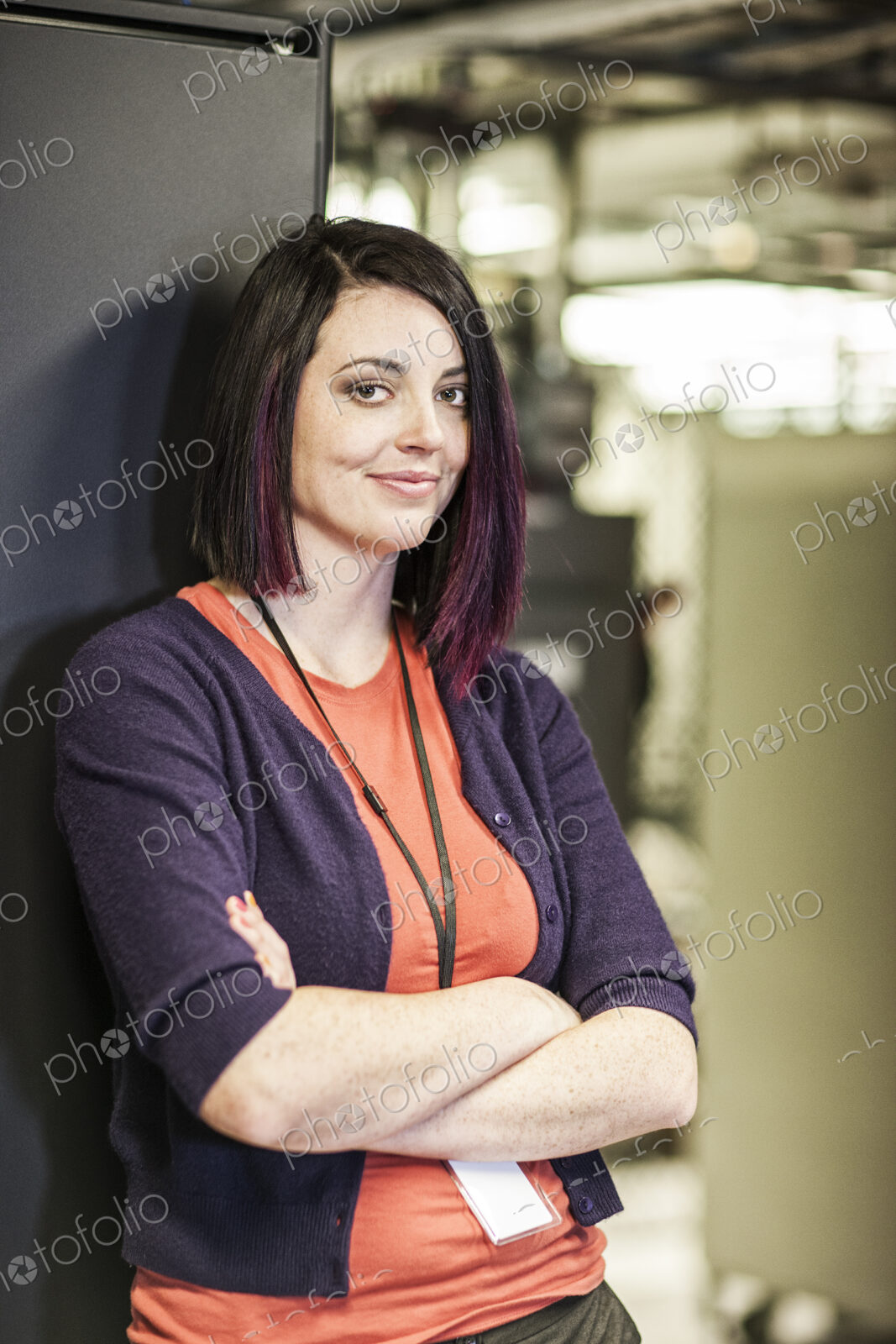 Caucasian woman technician in a large computer server farm.