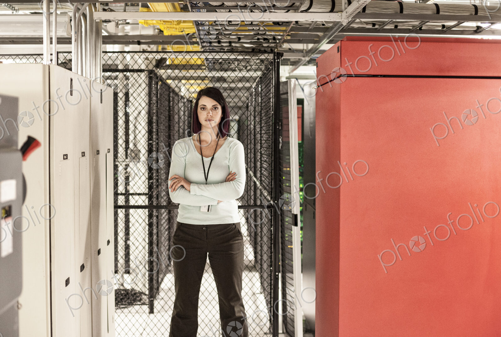 Caucasian woman technician in a large computer server farm.