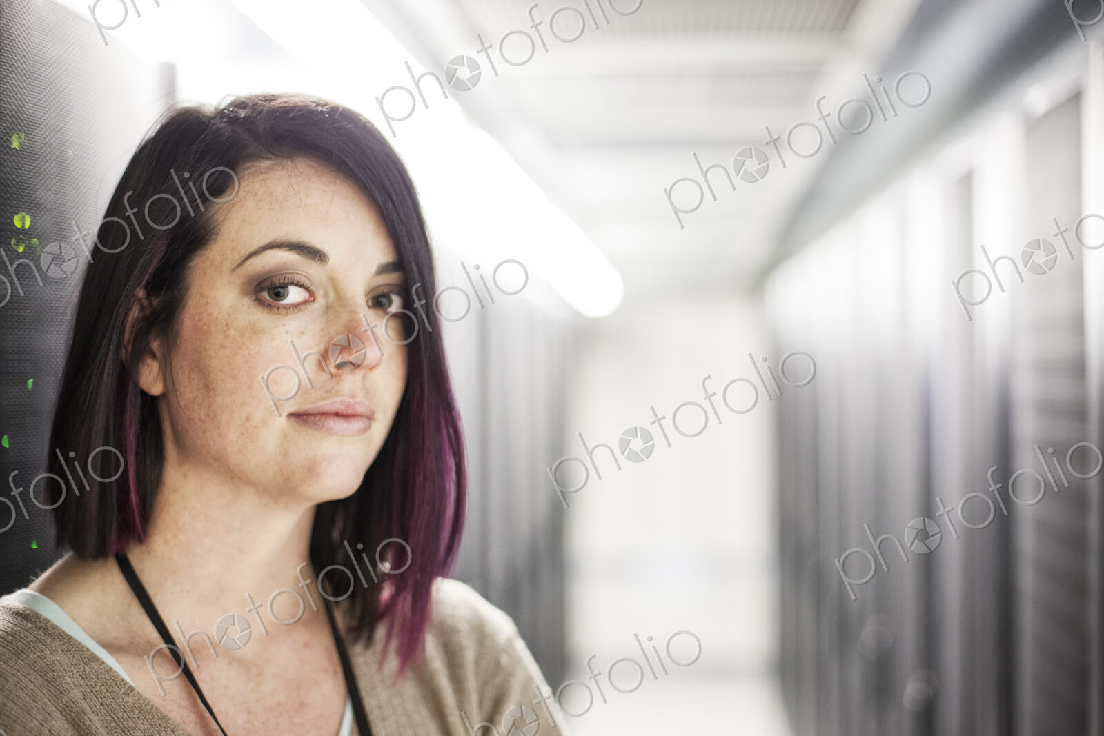 Caucasian woman technician in a large computer server farm.