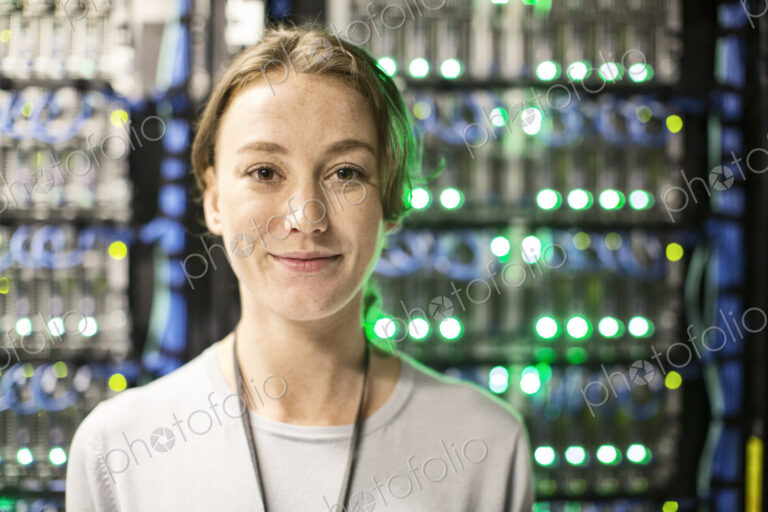 Caucasian woman technician in a large computer server farm.