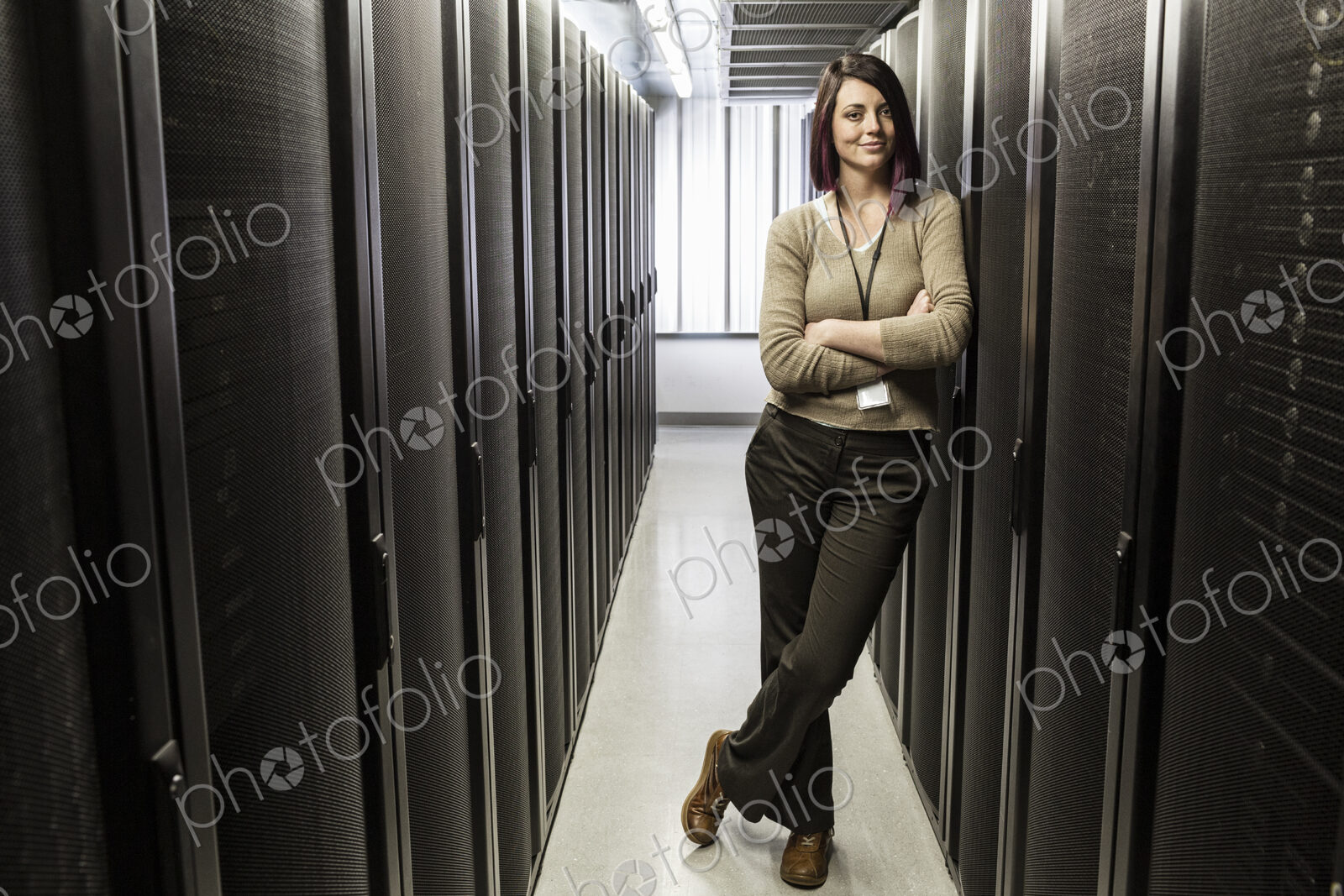 Caucasian woman technician in a large computer server farm.