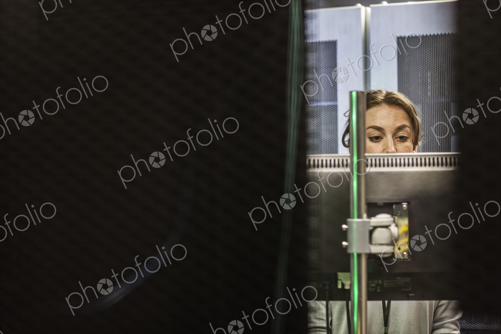 Caucasian woman technician working on computer servers in a server farm.