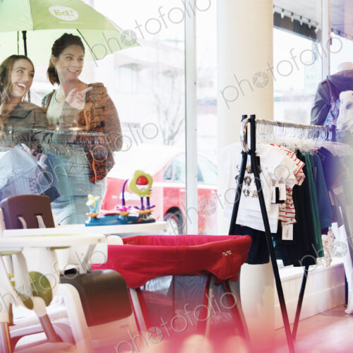 Caucasian women window shopping outside store