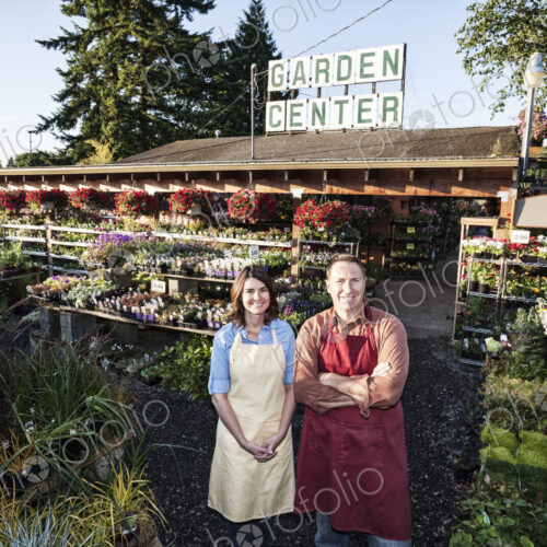 Caucasin man and woman garden center nursery owners.