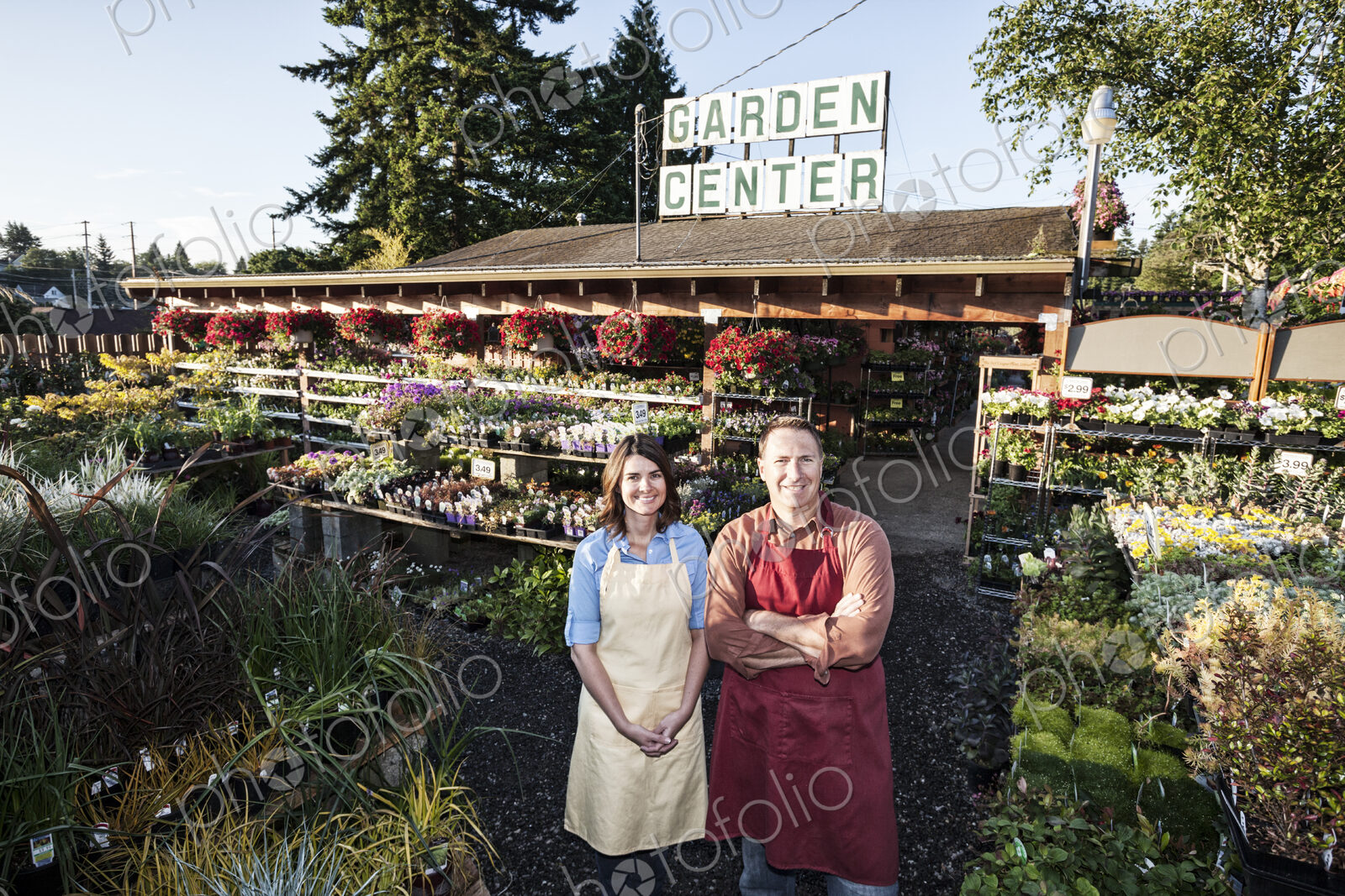 Caucasian man and woman garden center nursery owners.