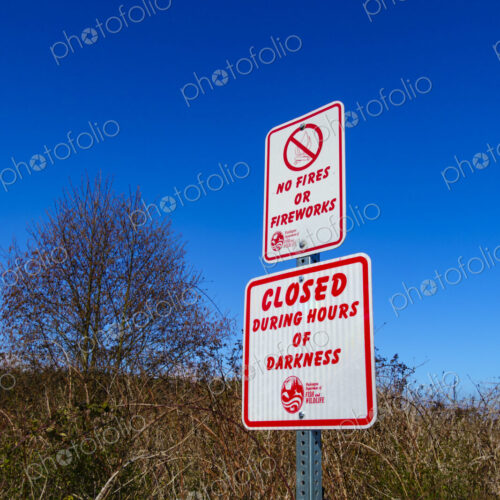 Caution and regulations signs in public park, Port Hadlock, WA USA Caution and regulations signs in public park, Port Hadlock, WA USA