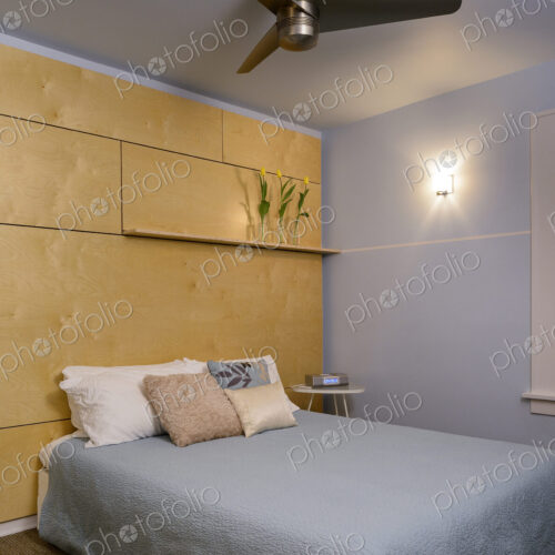 Ceiling fan and bed in modern bedroom