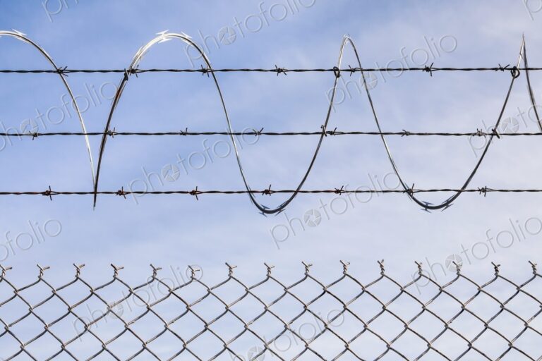 Chain link fence topped with barbed and razor wire, Portland, Oregon, USA