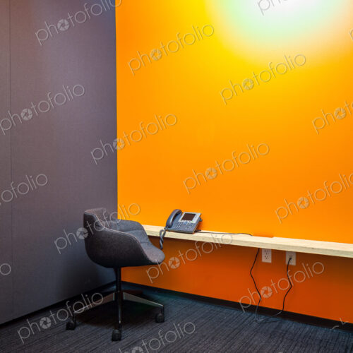 Chair, desk and phone in empty office