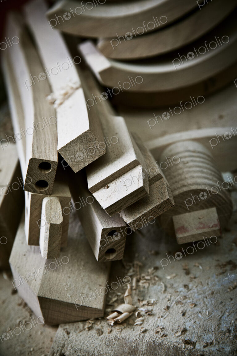Chair legs and parts of the chair back on a workbench.