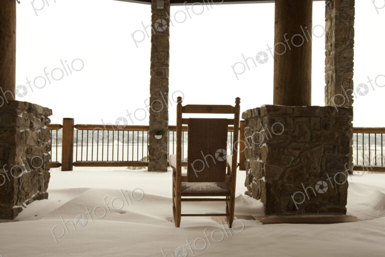 Chair on a Snowy Balcony