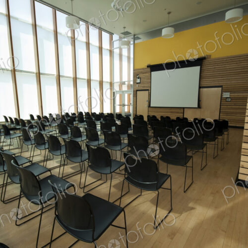 Chairs and projection screen in empty room
