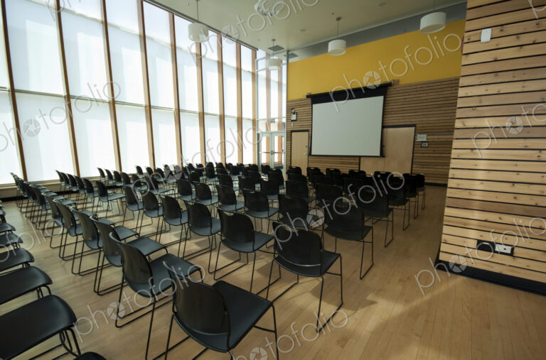Chairs and projection screen in empty room