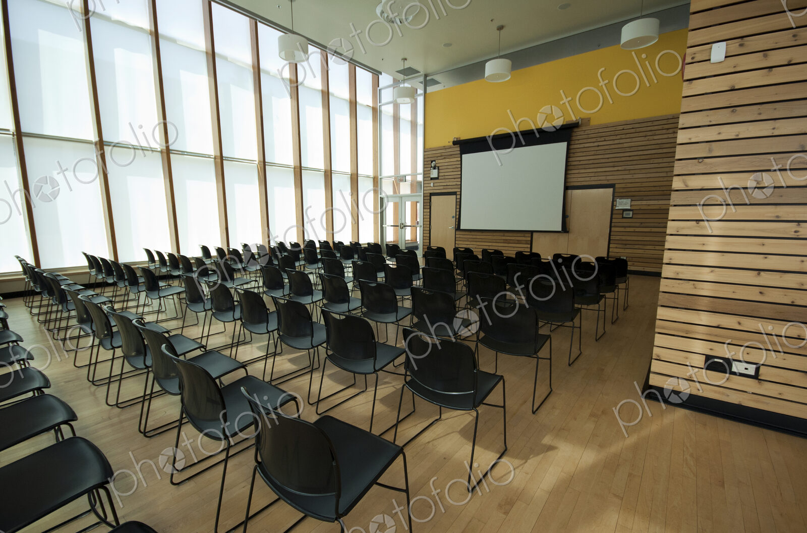 Chairs and projection screen in empty room