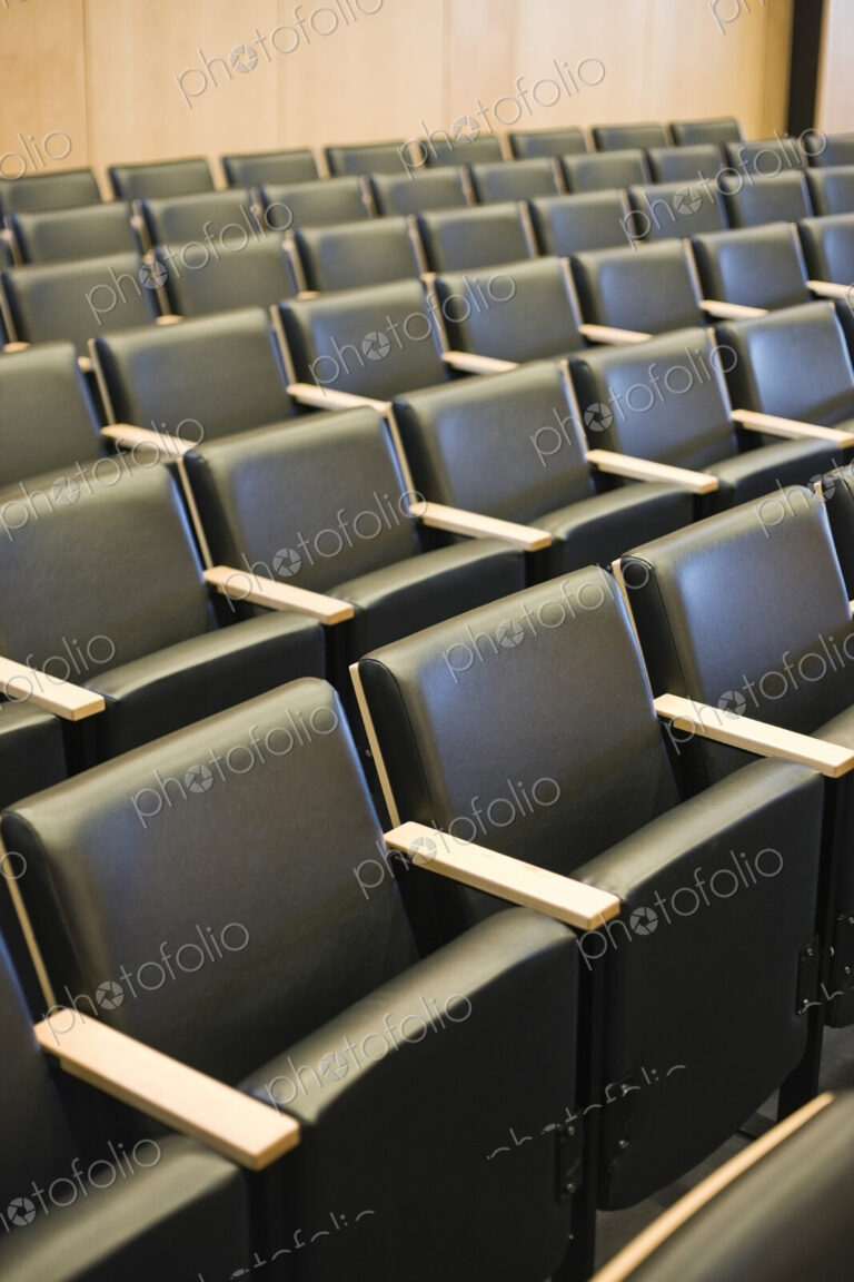 Chairs in a conference room or lecture theatre.