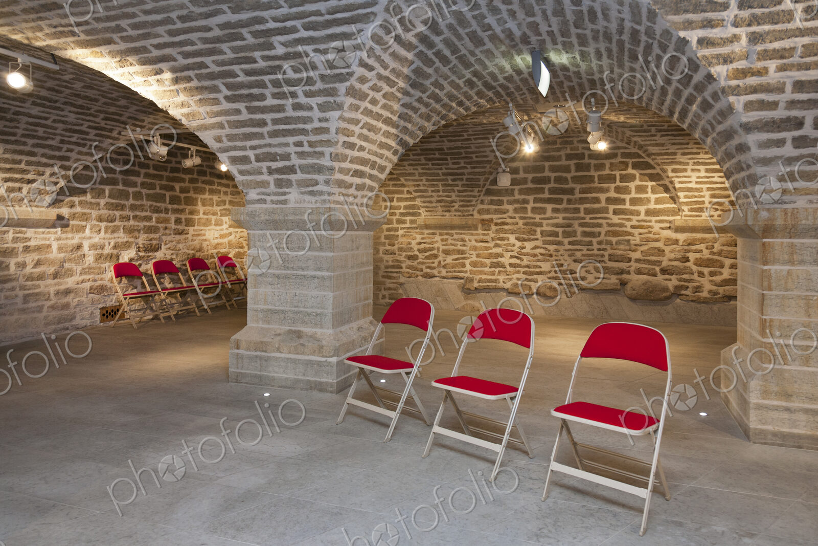 Chairs in a vaulted stone room for lectures meetings or seminars at a university