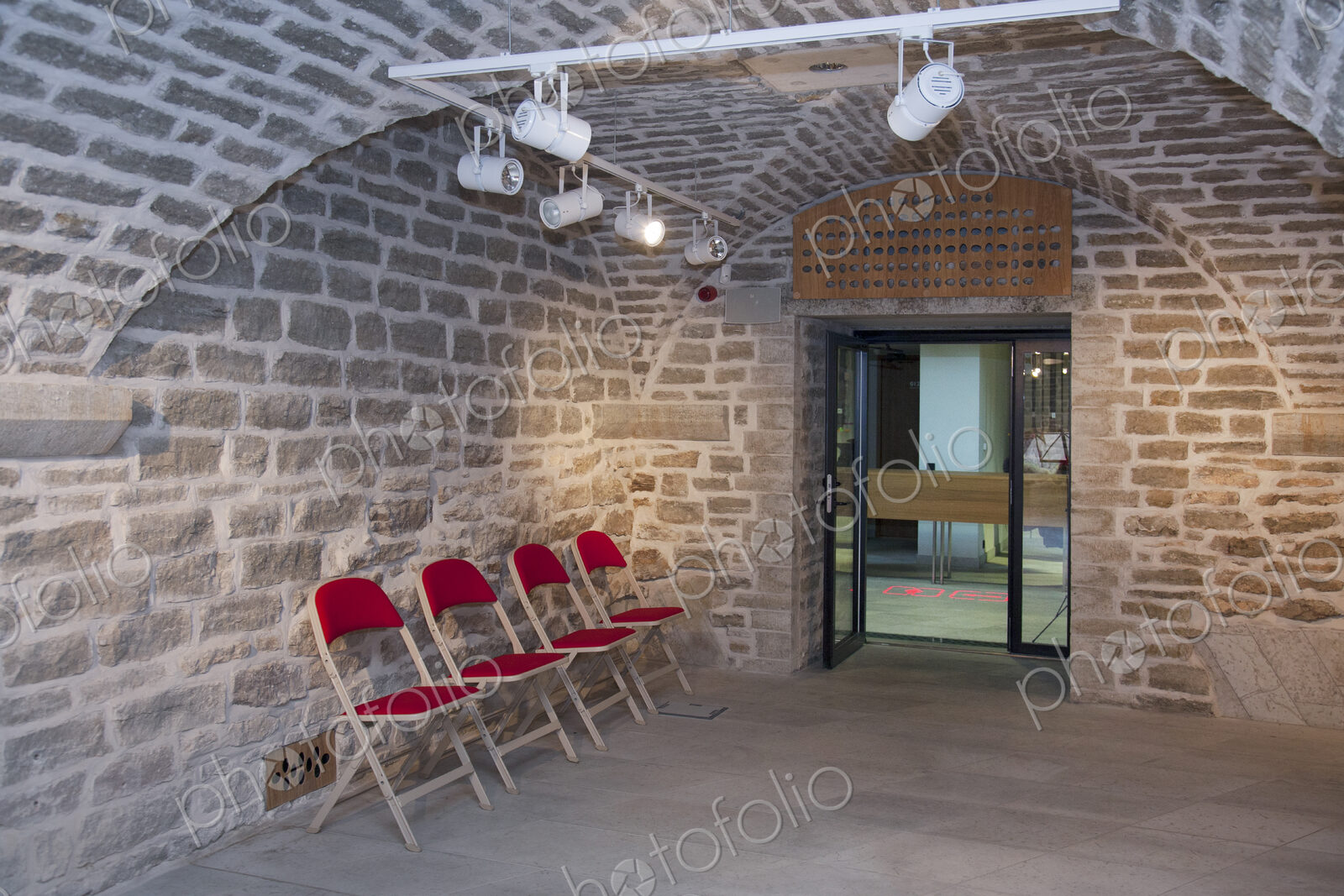 Chairs in a vaulted stone room for lectures meetings or seminars at a university