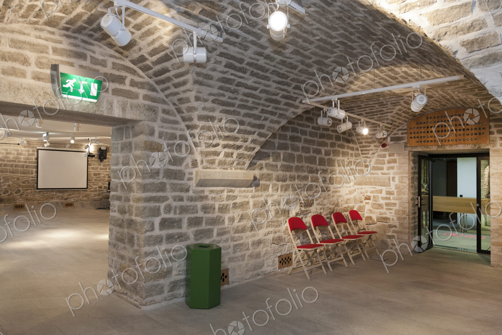 Chairs in a vaulted stone room for lectures meetings or seminars at a university