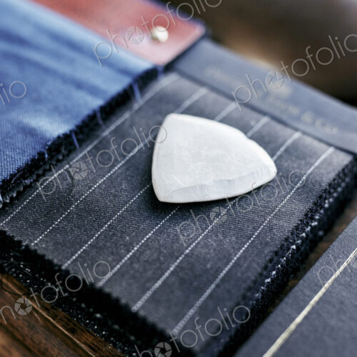 Chalk resting on cloth material samples used for making handmade suits Chalk resting on cloth material samples used for making handmade suits