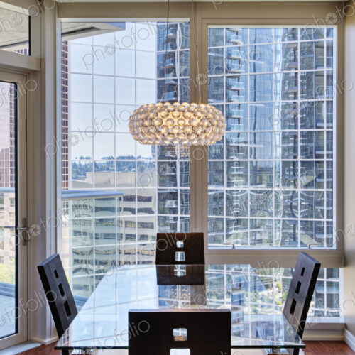 Chandelier over dining room in luxury highrise apartment