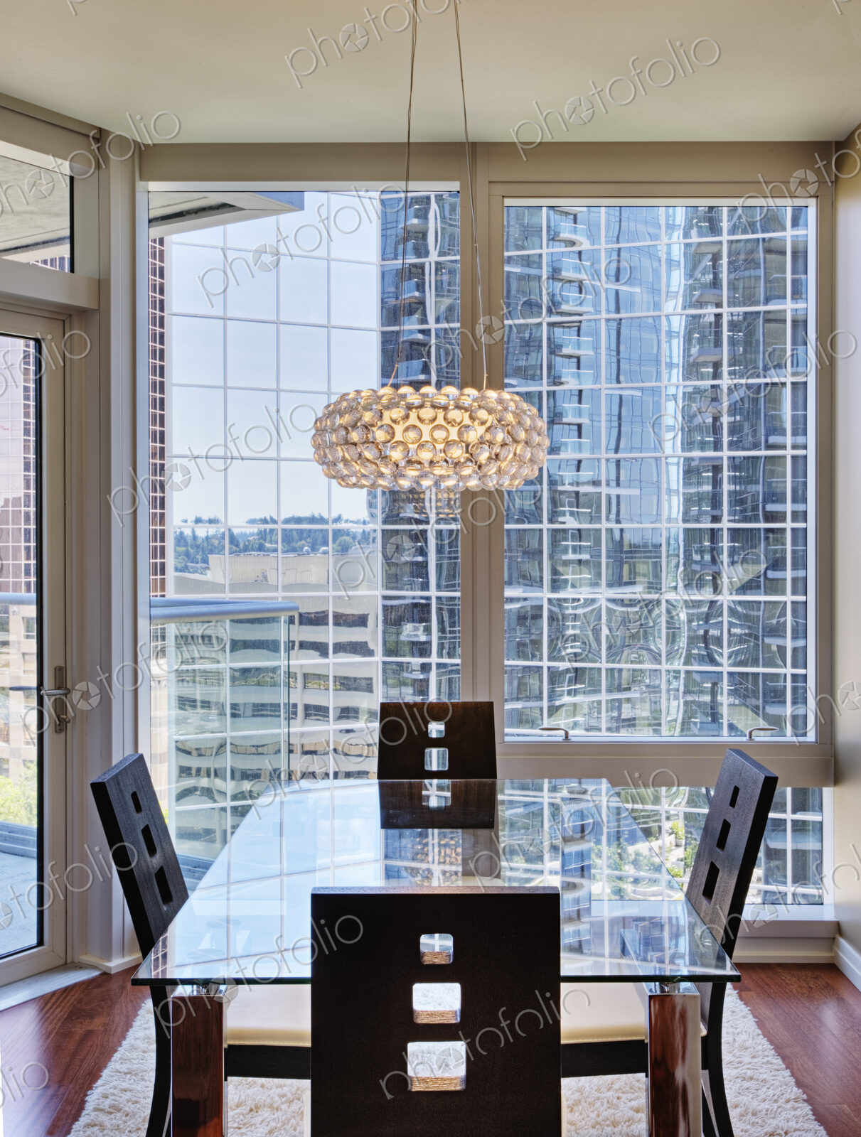 Chandelier over dining room in luxury highrise apartment